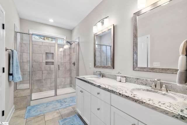 bathroom with tile patterned flooring, vanity, and an enclosed shower