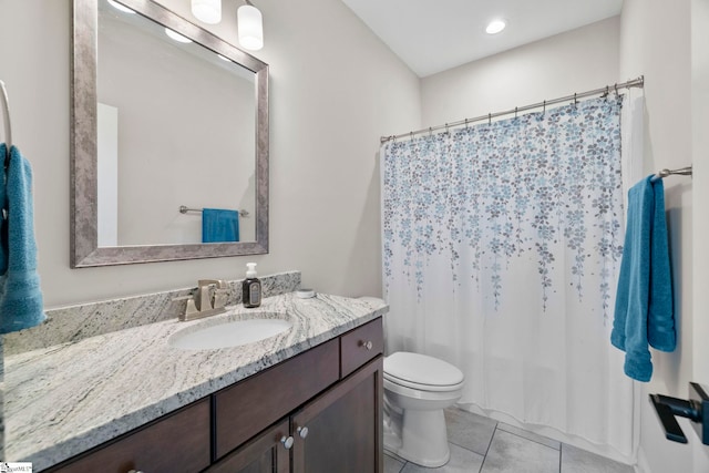 bathroom featuring toilet, vanity, and tile patterned floors