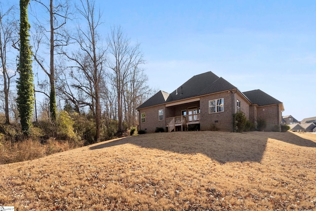 rear view of house featuring a lawn