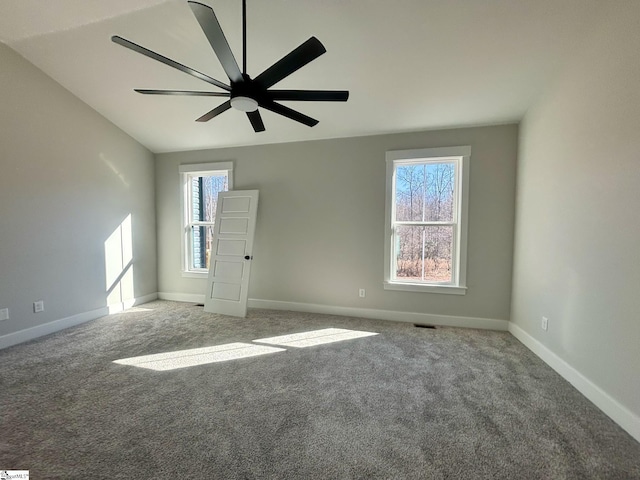 spare room featuring carpet, vaulted ceiling, and ceiling fan