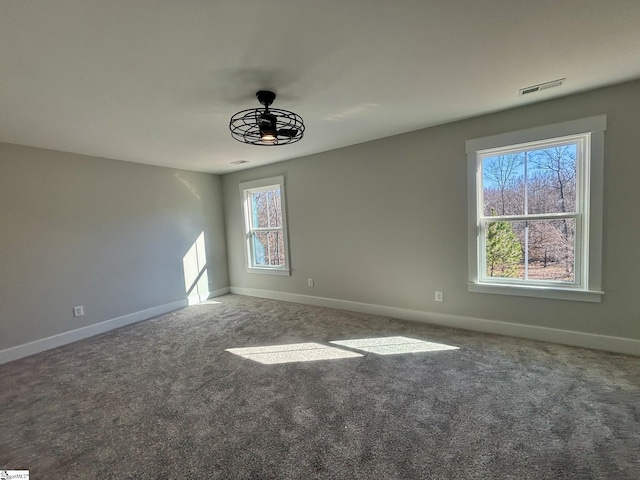 unfurnished room with carpet flooring, ceiling fan, and a healthy amount of sunlight