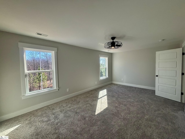 carpeted spare room featuring ceiling fan