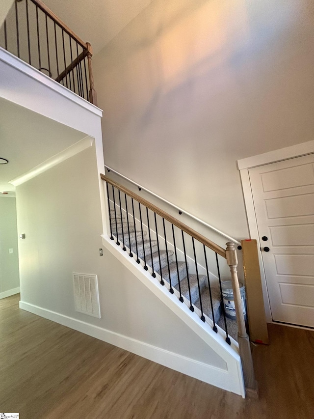 stairs with wood-type flooring