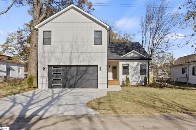 view of front of home featuring a garage and a front lawn