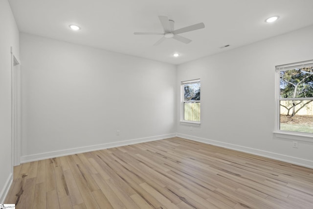 empty room with ceiling fan and light wood-type flooring