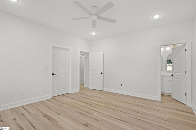 unfurnished bedroom with connected bathroom, ceiling fan, and light hardwood / wood-style floors