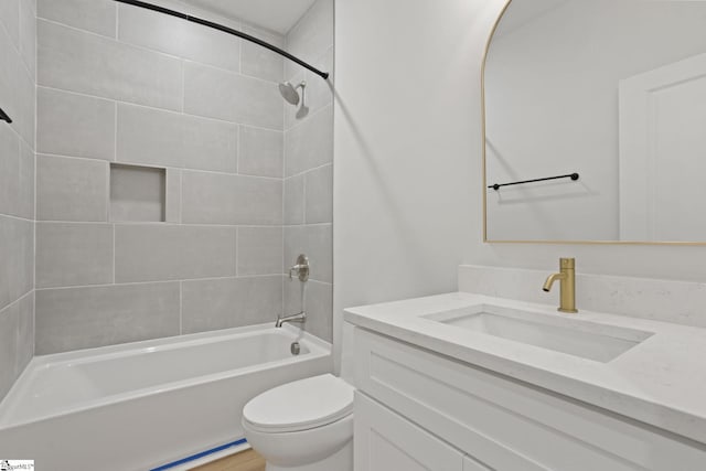 full bathroom with vanity, toilet, and tiled shower / bath combo