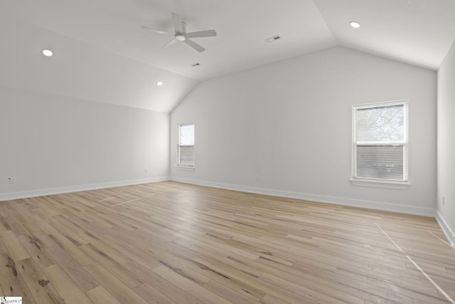 additional living space featuring ceiling fan, vaulted ceiling, and light wood-type flooring