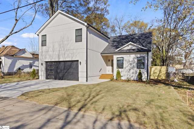 modern inspired farmhouse featuring a front lawn and a garage