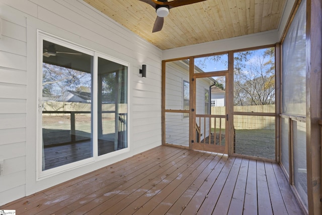 unfurnished sunroom featuring ceiling fan and wood ceiling