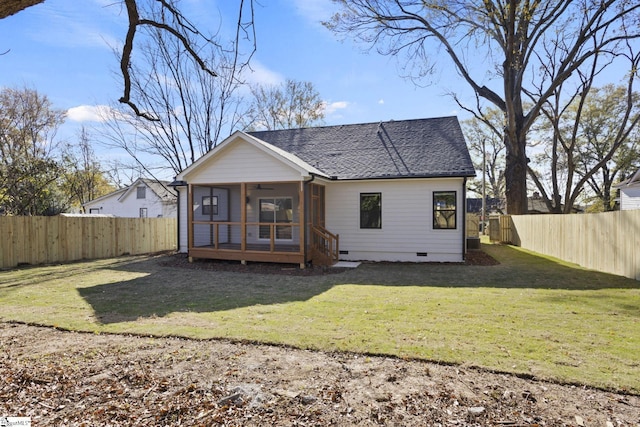 back of house with a sunroom and a lawn