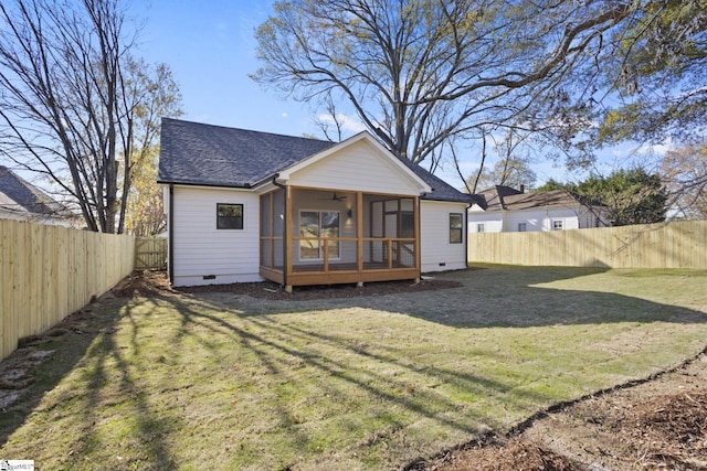 back of house featuring a yard and a sunroom