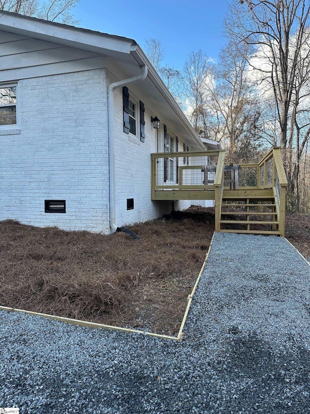 view of side of property with a wooden deck