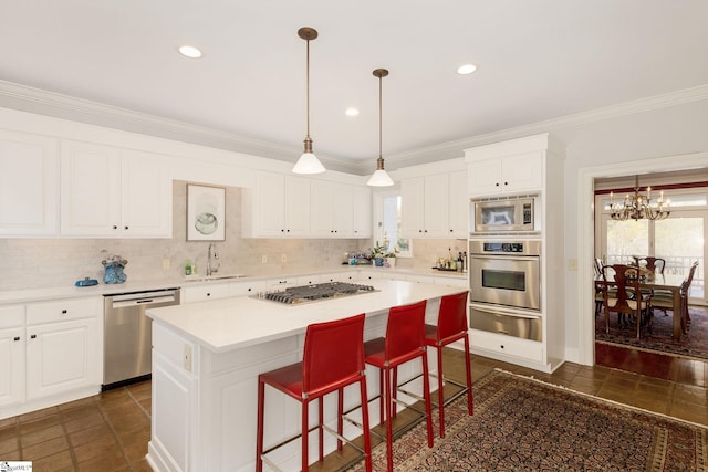 kitchen featuring white cabinets, a center island, stainless steel appliances, and a chandelier