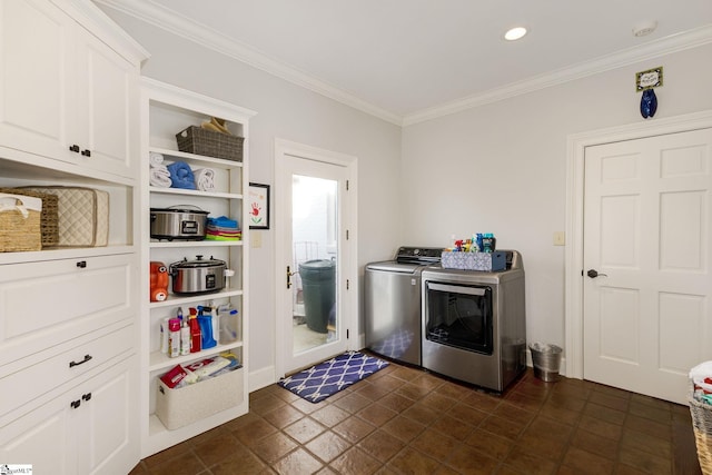 laundry area with washer and dryer, cabinets, and ornamental molding