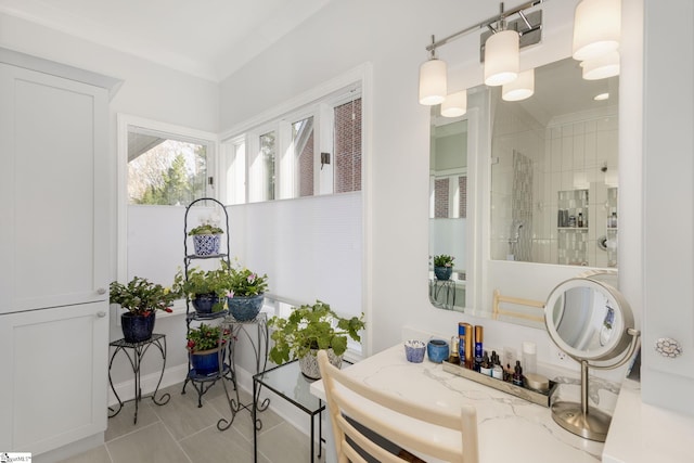 bathroom with tile patterned floors, ornamental molding, and walk in shower