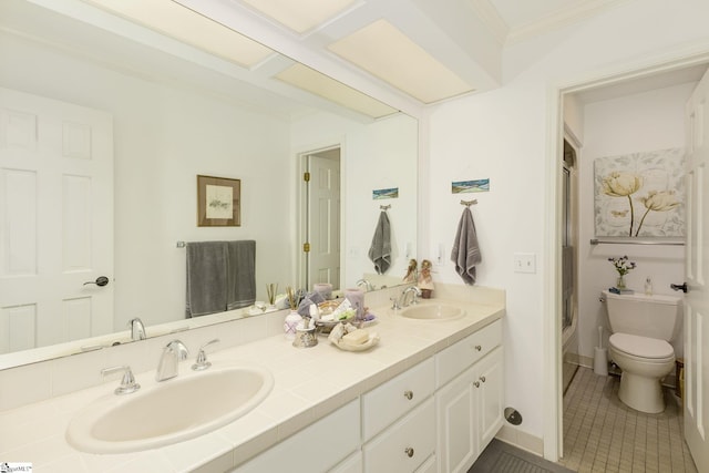 bathroom with tile patterned flooring, vanity, toilet, and crown molding