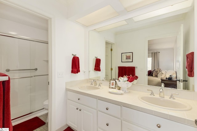 bathroom with vanity, toilet, and a shower with shower door