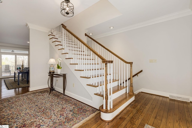 stairs featuring wood-type flooring and ornamental molding