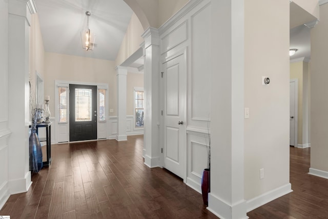 foyer entrance featuring vaulted ceiling and dark wood-type flooring