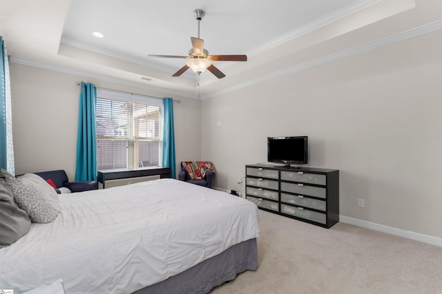 bedroom featuring a raised ceiling, ceiling fan, crown molding, and light carpet