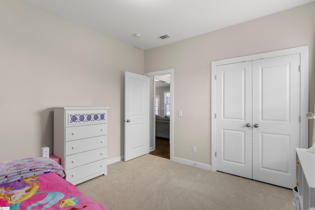 carpeted bedroom featuring a closet