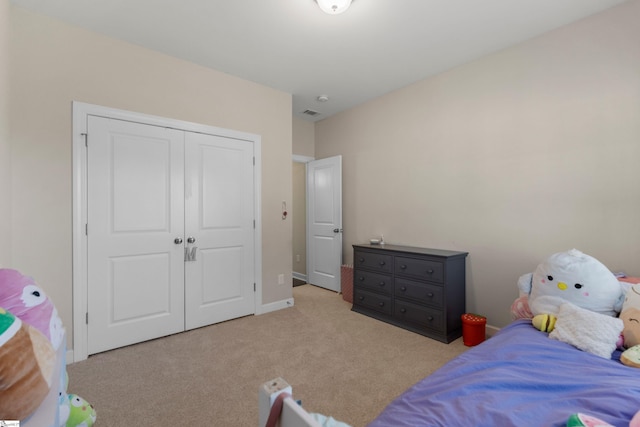 bedroom featuring a closet and light colored carpet