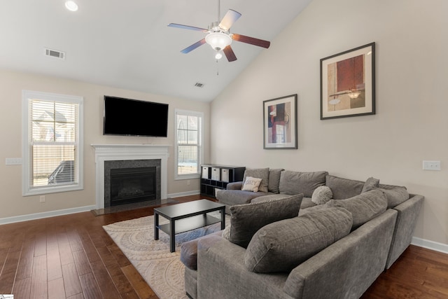 living room featuring ceiling fan, a healthy amount of sunlight, dark wood-type flooring, and high vaulted ceiling