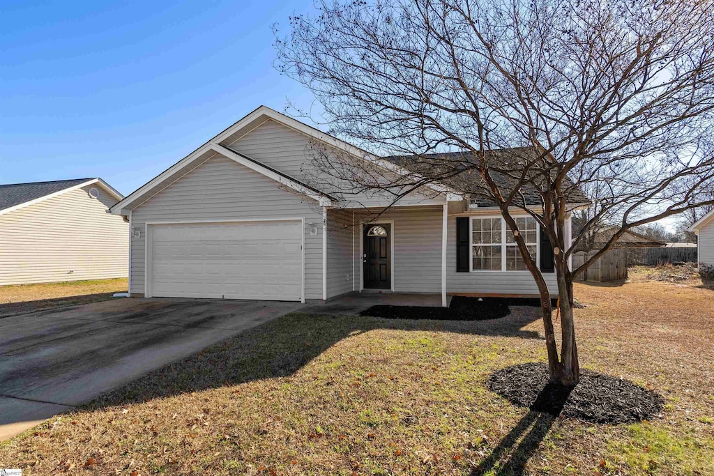 ranch-style house featuring a front lawn and a garage