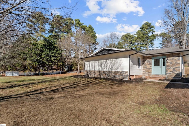 view of side of home with a lawn