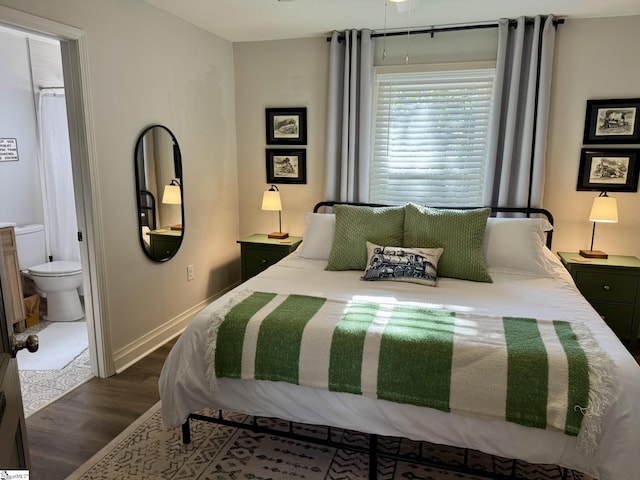 bedroom with dark hardwood / wood-style floors and ensuite bath