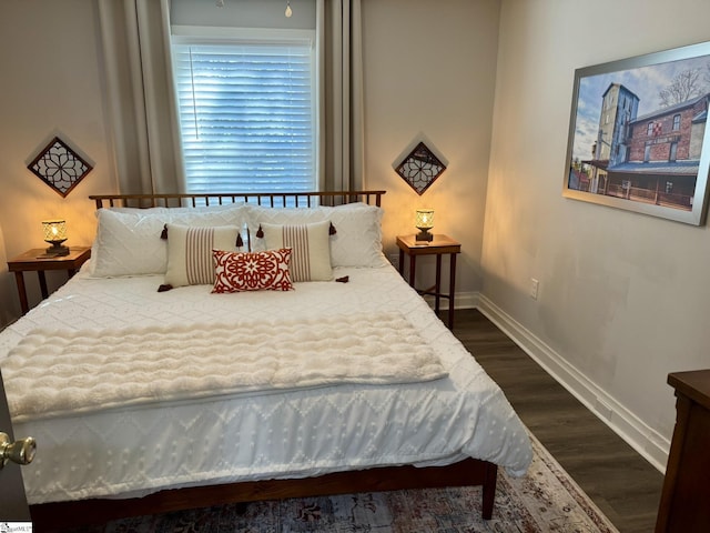 bedroom with dark hardwood / wood-style floors