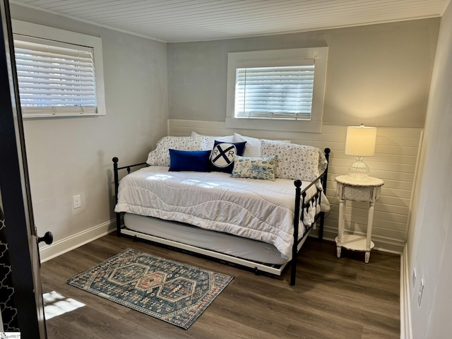 bedroom with dark hardwood / wood-style flooring