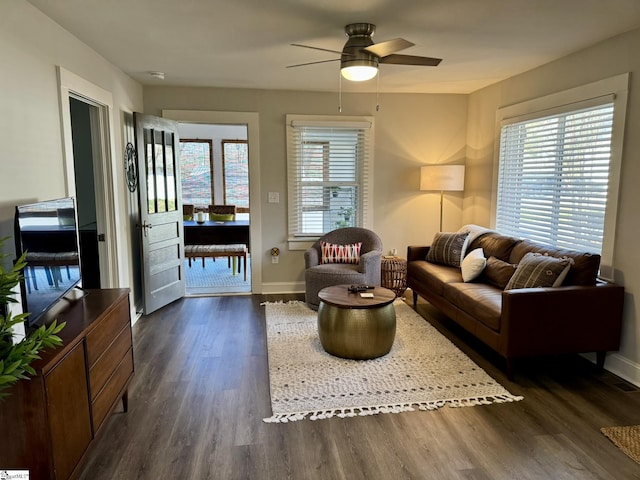 living room featuring dark hardwood / wood-style floors and ceiling fan