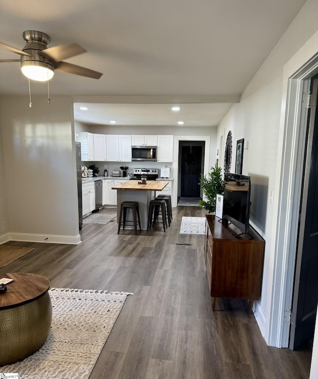 living room featuring hardwood / wood-style floors and ceiling fan