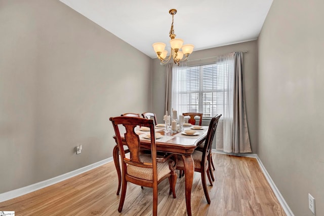 dining area featuring a chandelier and light wood-type flooring