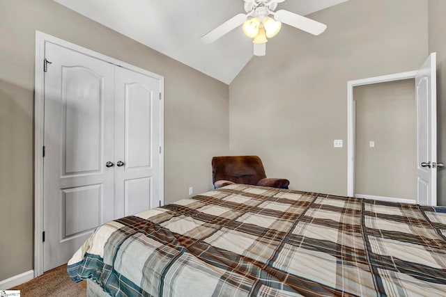 carpeted bedroom featuring ceiling fan, a closet, and vaulted ceiling