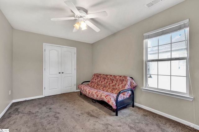 sitting room with ceiling fan, carpet floors, and a wealth of natural light