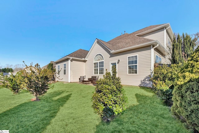 back of house featuring a yard