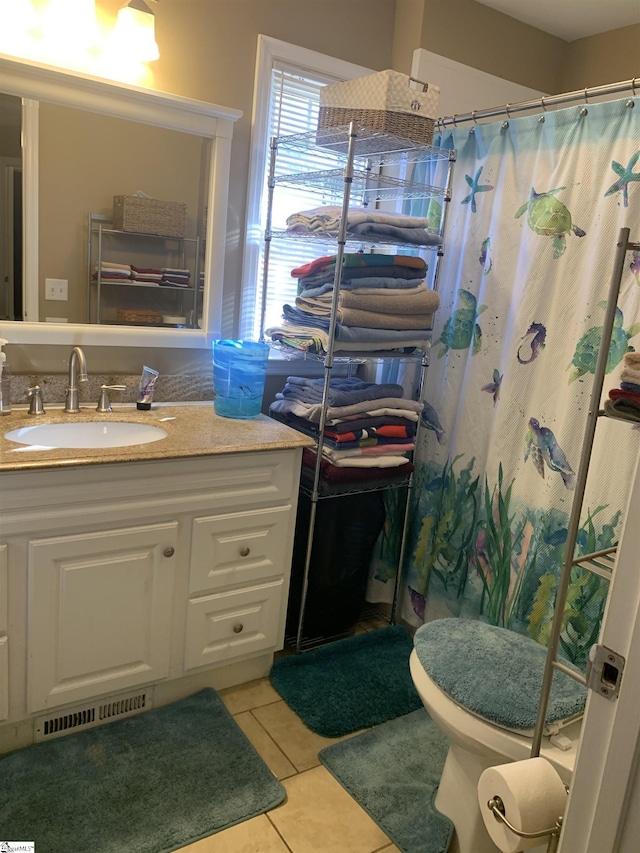 bathroom with tile patterned floors, vanity, a shower with shower curtain, and toilet