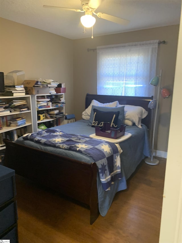 bedroom featuring ceiling fan and dark wood-type flooring