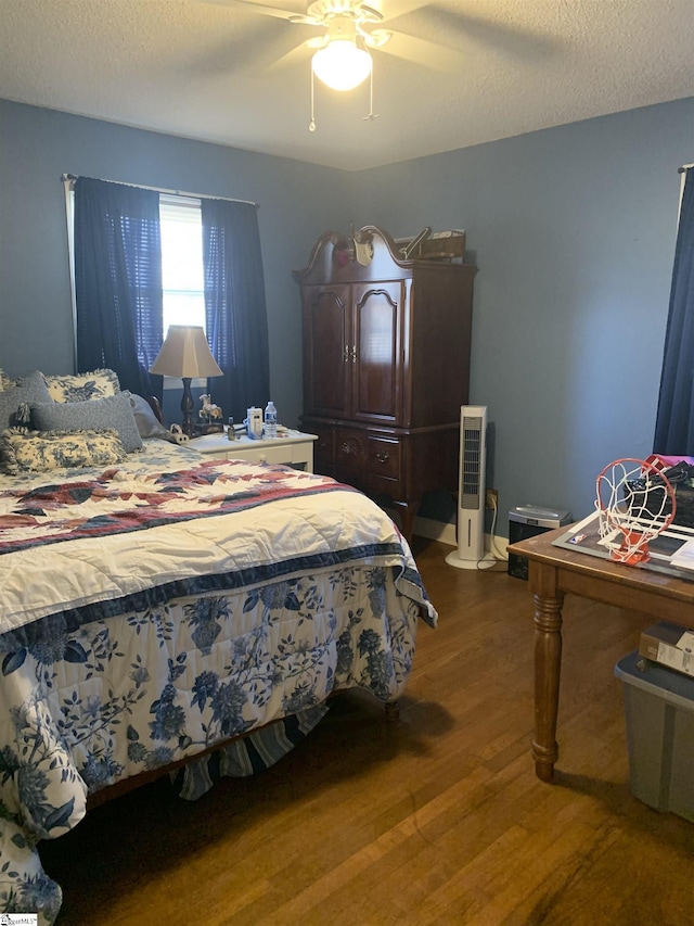 bedroom featuring hardwood / wood-style flooring, ceiling fan, and a textured ceiling