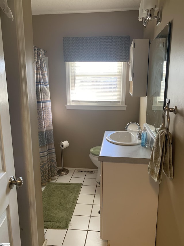 bathroom with tile patterned floors, vanity, and toilet