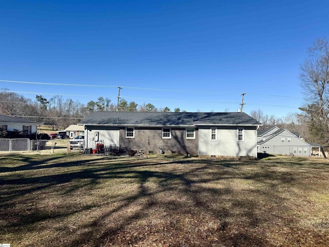 rear view of property with a lawn