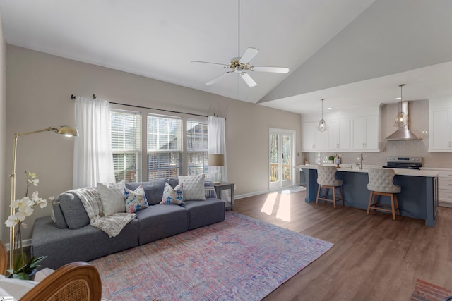 living room featuring light wood-type flooring, high vaulted ceiling, and ceiling fan