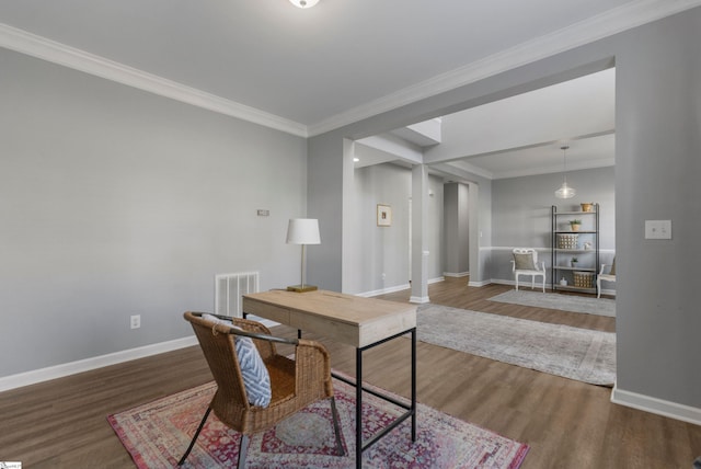 office with decorative columns, ornamental molding, and hardwood / wood-style flooring