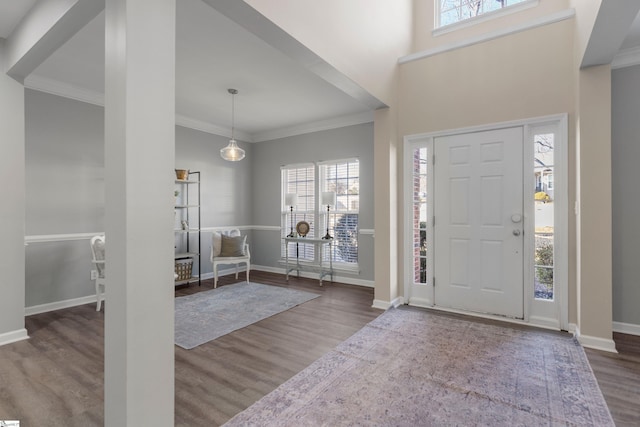 entrance foyer with hardwood / wood-style floors and crown molding