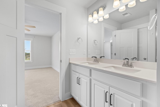 bathroom with ceiling fan, wood-type flooring, and vanity