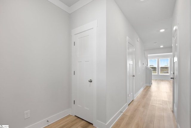 corridor with light hardwood / wood-style floors