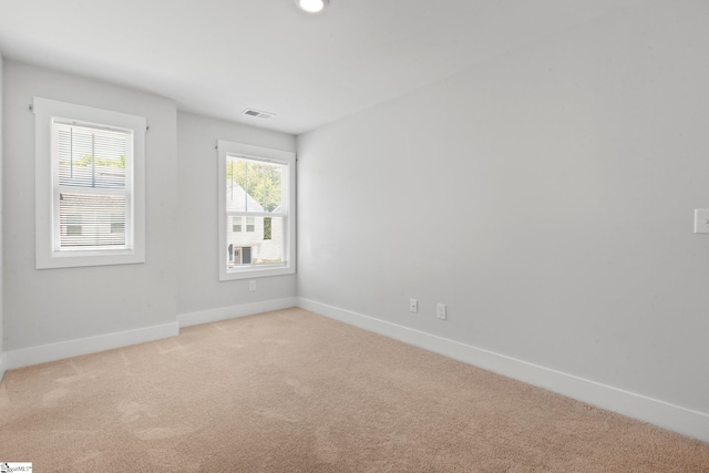 empty room featuring light colored carpet